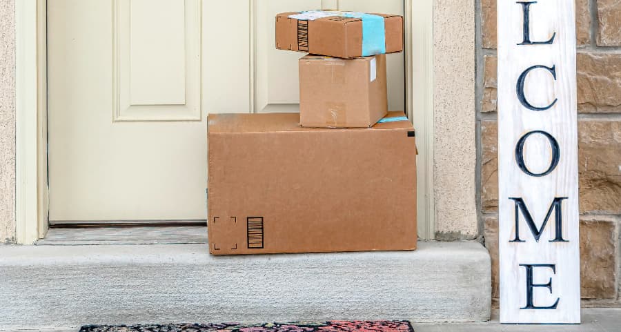 Boxes by the door of a residence with a welcome sign in Atlanta